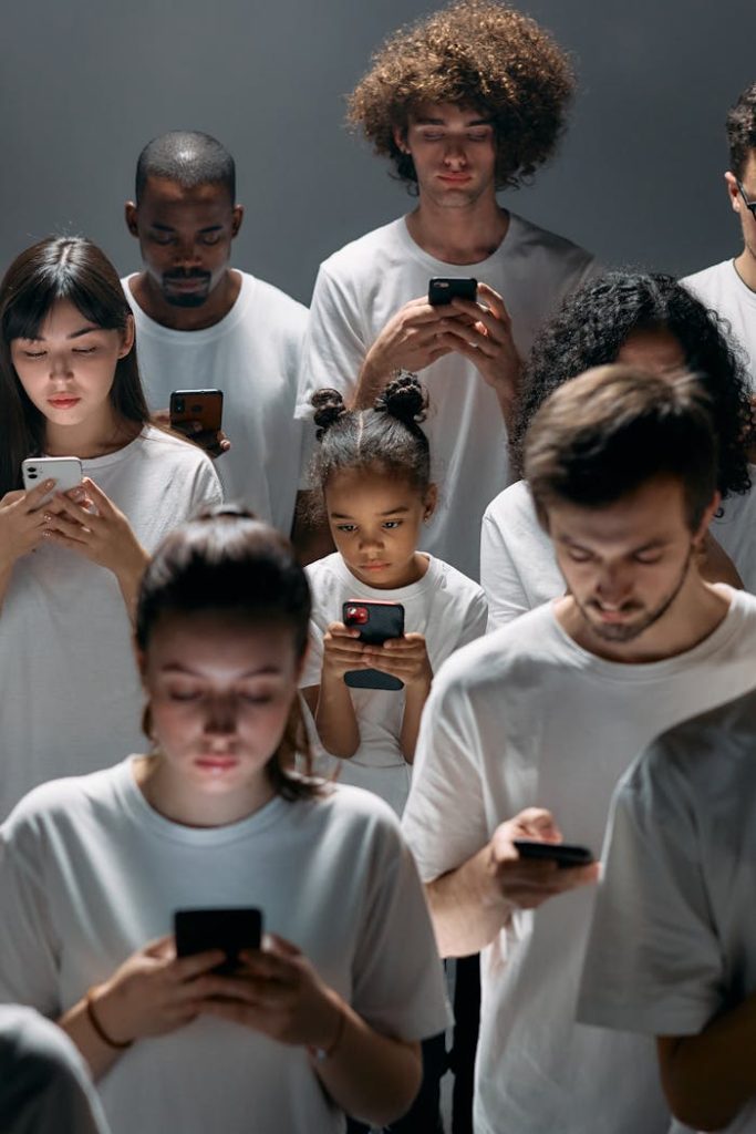 photo-of-people-engaged-on-their-phones-8088489 A diverse group of people focused on their smartphones, symbolizing modern technologys impact on social connection.